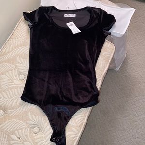 No longer has tags. Black velvet body suit. Worn once